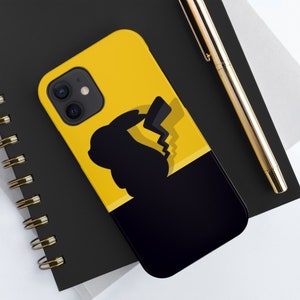 May include: A black and yellow phone case with a silhouette of Pikachu, a popular Pokemon character, on a black background. The phone case has a cut-out for the camera lens.