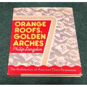 May include: A book with the title "ORANGE ROOFS, GOLDEN ARCHES" by Philip Langdon. The cover has a red panel with yellow text and a geometric pattern. The subtitle reads "The Architecture of American Chain Restaurants."