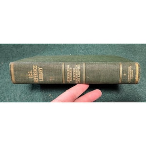May include: A green hardcover book with gold lettering titled "I.C.S. Reference Library" and "Alternating Currents, Electric Transmission and Lighting". The book is part of the International Correspondence Schools series and is volume 3.