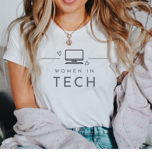 May include: A white t-shirt with a black and white graphic of a computer screen and the text "Women in Tech".