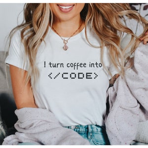 May include: A white t-shirt with the text "I turn coffee into </CODE>" printed on the front.