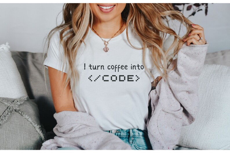 May include: A white t-shirt with the text "I turn coffee into </CODE>" printed on the front.