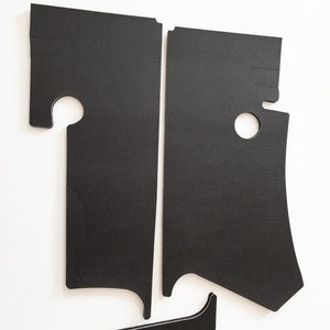 May include: Three black pieces of foam insulation with cutouts for a car door panel.