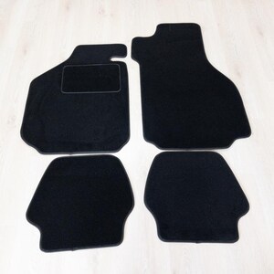 May include: Set of five black car floor mats. The mats are made of a soft, plush material and have a non-slip backing.