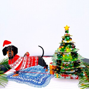 Carte pop-up 3D de Noël pour chien teckel. Une carte de voeux surprise délicieuse et amusante pour les enfants, les amis, la famille et les proches, 20 x 15 cm