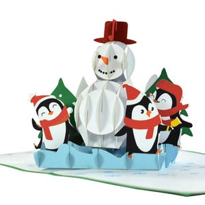 Tarjeta emergente 3D con alegre muñeco de nieve y pingüinos navideños. Un regalo encantador de tarjeta de felicitación para niños, amigos, familiares y seres queridos. 15 cm x 15 cm