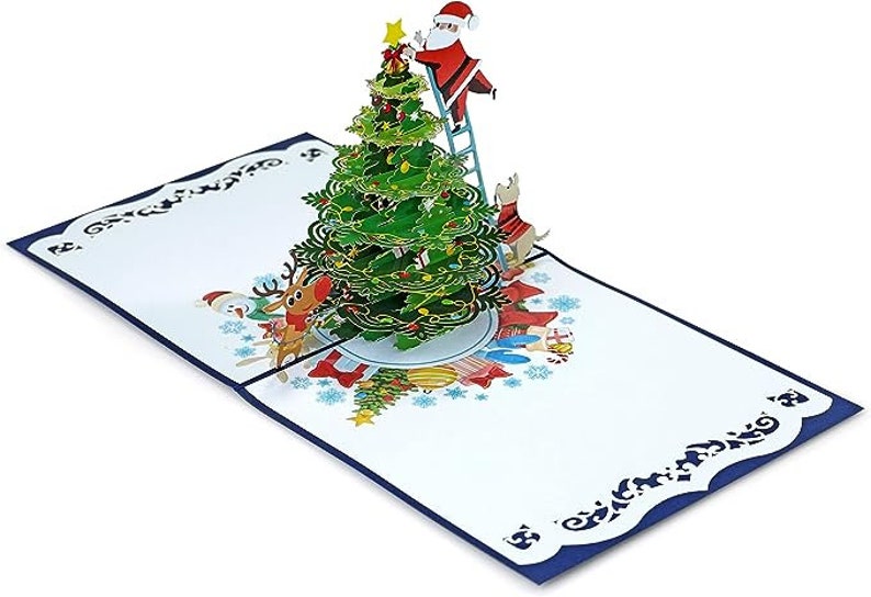 Carte pop-up 3D du Père Noël décorant un sapin de Noël. Une délicieuse carte de voeux surprise pour les enfants, les amis et la famille. 15 cm x 15 cm image 4