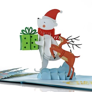 Biglietto pop-up 3D con orso e renna di Natale. Un delizioso biglietto di auguri a sorpresa per le feste, regalo per bambini, amici, famiglia. 15 cm x 15 cm
