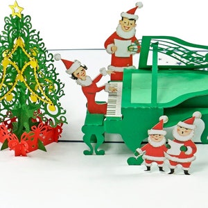 Biglietto pop-up 3D Christmas Carols Cheer. Un delizioso biglietto di auguri per le feste, un regalo per bambini, amici, familiari e persone care. 15 cm x 20 cm.