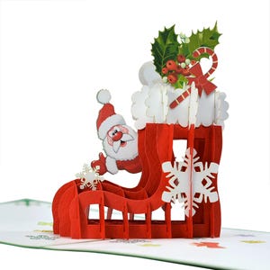Tarjeta emergente 3D con media de regalo roja de Papá Noel. Una encantadora tarjeta de felicitación sorpresa navideña para regalar a niños, amigos y familiares. 15 cm x 15 cm