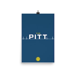 May include: A poster with a dark blue background features the white text "THE PITT" with a heartbeat line beneath. The top of the poster is held by a silver clip. A yellow and black logo is at the bottom.