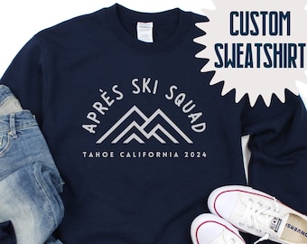 Könnte beinhalten: Navyblauer Sweatshirt mit dem Text "Après Ski Squad" und "Tahoe California 2024" in Weiß. Der Sweatshirt zeigt eine Grafik mit drei Bergen.