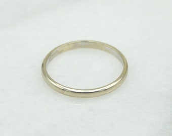 May include: A simple, plain gold wedding band.