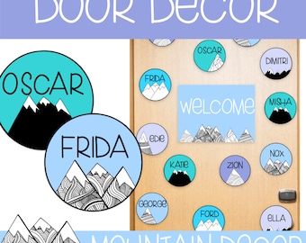 May include: A set of 14 round, colourful door decorations with mountain and snow designs. Each circle features a different name, such as Oscar, Frida, and Misha. The welcome sign has a blue background with white text and a mountain design. The text "Mountain Decor" is at the bottom of the image.
