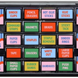May include: A black plastic storage cabinet with multiple drawers, each featuring a label with a blue and white striped background, a wavy orange line, and text identifying office supplies like Pencils, Binder Clips, Erasers, and Glue.