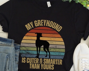 May include: Black t-shirt with a vintage-style graphic of a greyhound dog and the text "My Greyhound is cuter & smarter than yours".