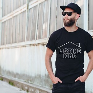 May include: A man wearing a black t-shirt with a white graphic of a house and the text "LISTING KING". He is wearing a black baseball cap and sunglasses.