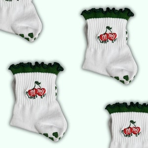 In my Pilates era dark green ruffle grip sock with cherry and green heart grips for Pilates, yoga, Lagree or barre