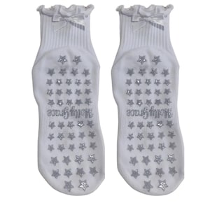White non slip grip sock with white bow and silver glitter star grips for Pilates, yoga, lagree or barre