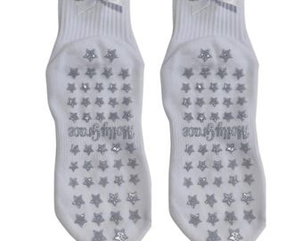 White non slip grip sock with white bow and silver glitter star grips for Pilates, yoga, lagree or barre