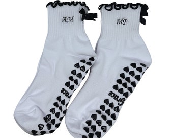 Custom initial black and white grip socks with bow and heart grips, perfect for Pilates, Yoga, Barre or lagree