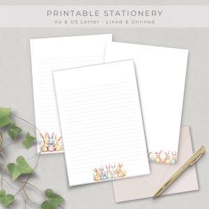 May include: Printable stationery featuring lined and unlined A4 and US Letter paper. The paper has a watercolor illustration of bunnies and Easter eggs. A matching envelope and gold pen are also included.