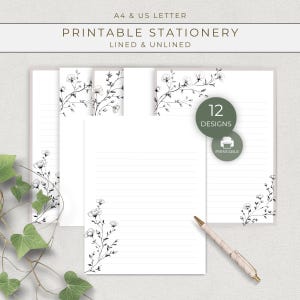 Puede incluir: Papelería imprimible blanca con detalles florales. La papelería incluye páginas rayadas y sin rayar, con el texto "PRINTABLE STATIONERY" y "12 DESIGNS". Un bolígrafo descansa sobre la papelería.