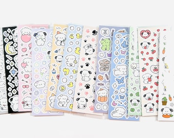 以下が含まれることがあります： 様々なデザインのステッカーシートのコレクション。ステッカーには、漫画の子犬、ハート、花、その他のキュートなイラストが含まれています。カラーパレットはソフトで、ピンク、ブルー、イエロー、グリーンのパステルカラーです。