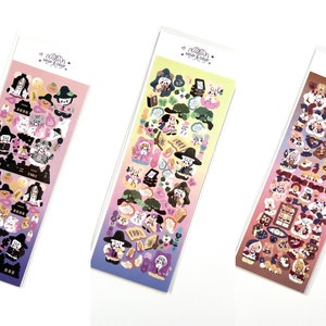 May include: Three sticker sheets with colorful illustrations of cartoon characters, including witches, cats, and food items. The stickers are packaged in clear plastic sleeves with the text "Wear & Decor" at the top.