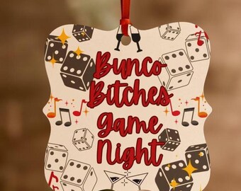 May include: A white and red Christmas bauble with a dice pattern and the text "Bungo Bitches Game Night".