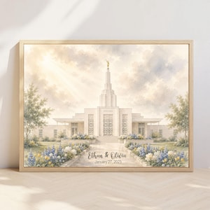 May include: A framed watercolor print of a temple with a central spire and gold statue, surrounded by gardens with blue and yellow flowers. The text "Ethan & Olivia" and "January 27, 2023" is printed in the center foreground on the walkway.