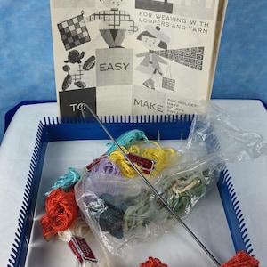 May include: A blue adjustable loom kit with a variety of colorful yarn and instructions for weaving pot holders, hats, and scarves. The kit includes a metal needle and a booklet titled "LOOM" with illustrations.