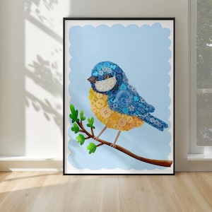May include: A framed art print featuring a bluebird crafted from buttons. The bird is perched on a brown branch with green leaves against a light blue background. The artwork is in a black frame and is displayed in a room with natural light.