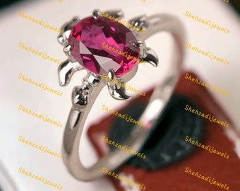 ユニークなルビーターテルリング、オーバルカットステートメントリング