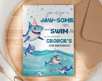 May include: A blue and white birthday invitation with a shark and the text "Join us for a Jaw-some Time and Swim over as we celebrate George's 5th Birthday!"