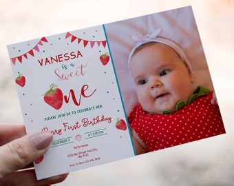 May include: A white card with a red and green strawberry theme. The card says "Vanessa is a Sweet One" and has a photo of a baby girl wearing a red and white polka dot dress. The card also includes the text "Please join us to celebrate her First Birthday, December 3 at 2:00 PM".