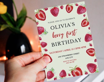 May include: A light green and white birthday invitation with a strawberry theme. The invitation says "Olivia's berry first birthday" and includes the date, time, and location of the party. RSVP information is also included.