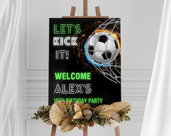 May include: A black and green welcome sign with a soccer ball in a net. The sign says "Let's Kick It!" and "Welcome Alex's 10th Birthday Party".