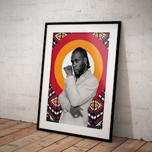 May include: A framed black and white portrait of a man with a beard and a white shirt. The background is a red and yellow circle with a black and white pattern.