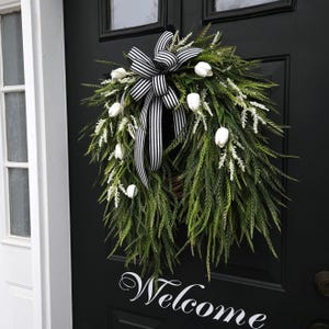 Corona de tulipanes blancos de primavera: decoración para la puerta principal con hierba de sierra y lazo a rayas.