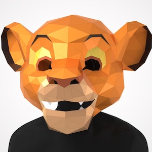May include: A geometric, orange lion mask with black detailing. The mask features a polygonal design, with visible edges and facets. The lion's face includes open eyes, a nose, and a smiling mouth with teeth. The mask is worn over a black top.