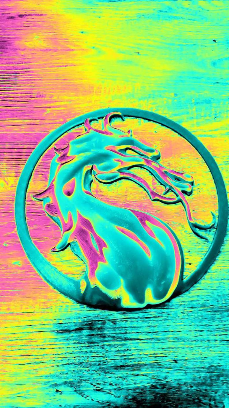 May include: A teal blue dragon logo with a pink outline, set against a yellow and blue background. The dragon is in a circle with a black outline.