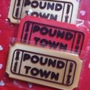 May include: Three brown and red ticket-shaped paper gift tags with the text "Pound Town" printed on them.