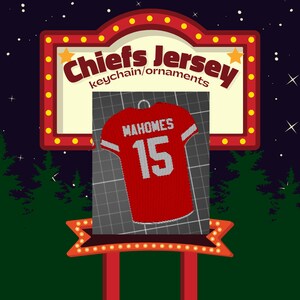 May include: Red and white Chiefs jersey ornament with the name "Mahomes" and the number "15" on the back. The ornament is hanging from a string.
