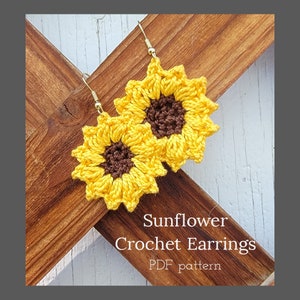 May include: A pair of crocheted sunflower earrings with brown centres. The earrings are hanging from gold hooks. The text "Sunflower Crochet Earrings PDF pattern" is visible below the earrings.