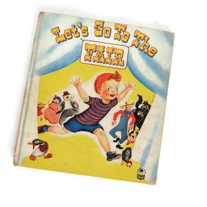 Stara książka dla dzieci z 1951 r. „Let's Go To The Fair” autorstwa Mickey'ego Klara Marksa. Przytulna książka dla dzieci nr 2071-25 z ilustracjami Irmy Wilde Whitman. Wyd.