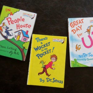 May include: Three children's books by Dr. Seuss and Theo. LeSieg. The books include "In a People House", "There's a Wocket in my Pocket!", and "Great Day for Up". The covers feature colorful illustrations and text.