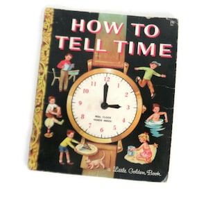 May include: A vintage children's book titled "How to Tell Time" with a black cover and a large illustration of a clock with moving hands. The book is part of the Little Golden Book series.