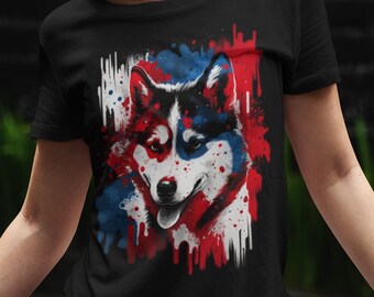 May include: A black t-shirt with a colorful graphic of a husky dog's face. The graphic is in shades of red, white, and blue, with paint splatters and drips.