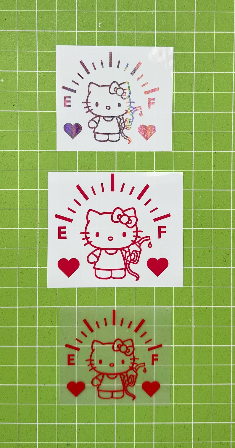 May include: Three vinyl decals featuring a Hello Kitty character holding a gas pump nozzle. Each design includes a fuel gauge arc labeled E and F, and two hearts. The top decal is holographic, while the middle and bottom decals are solid red.